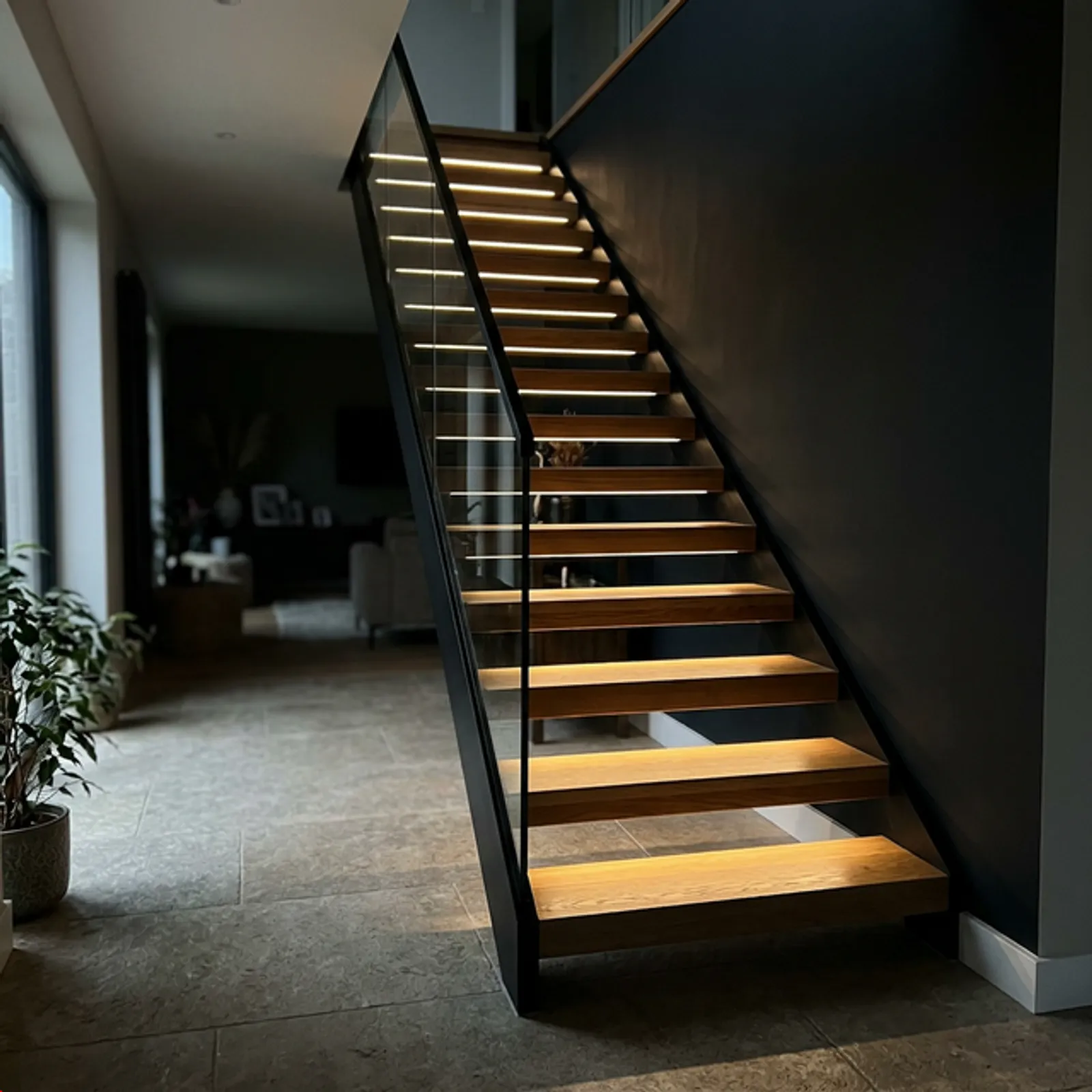 Floating staircase with integrated LED lighting under the treads